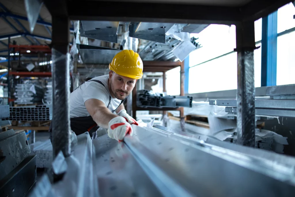 factory worker working warehouse handling metal material production