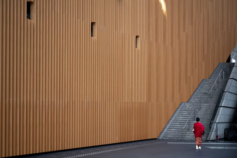 person standing in front of big wall 